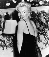marilyn_monroe_posing_with_her_broken_shoulder_strap_during_a_press_conference_in_london2C_1956_.jpg